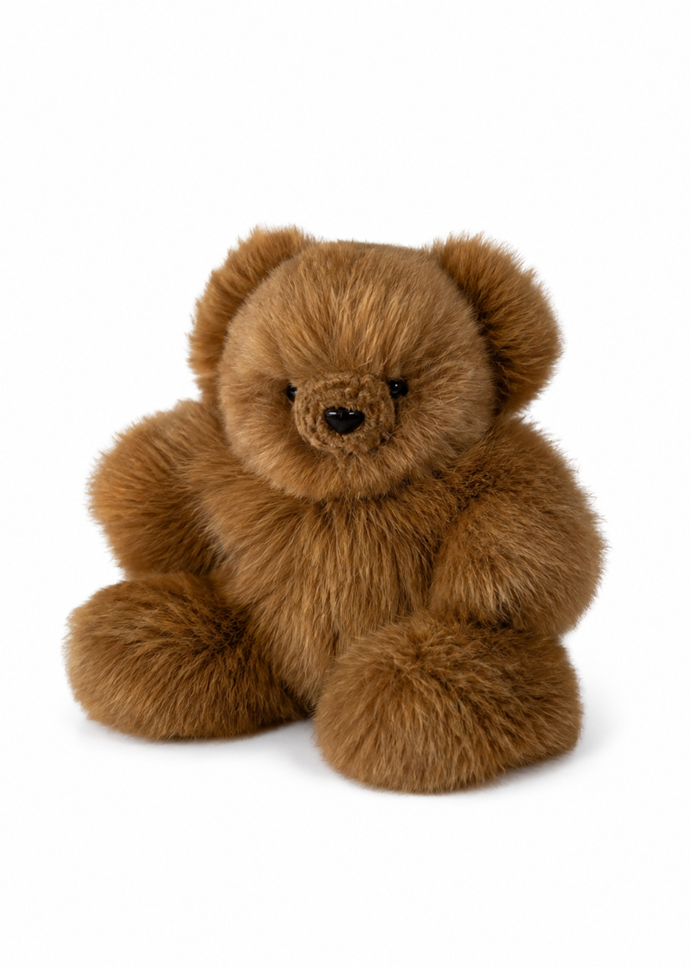 A fluffy brown-colored teddy bear plush toy made of a soft alpca fur, small black eyes, and a stitched brown nose, shown against a plain white background.