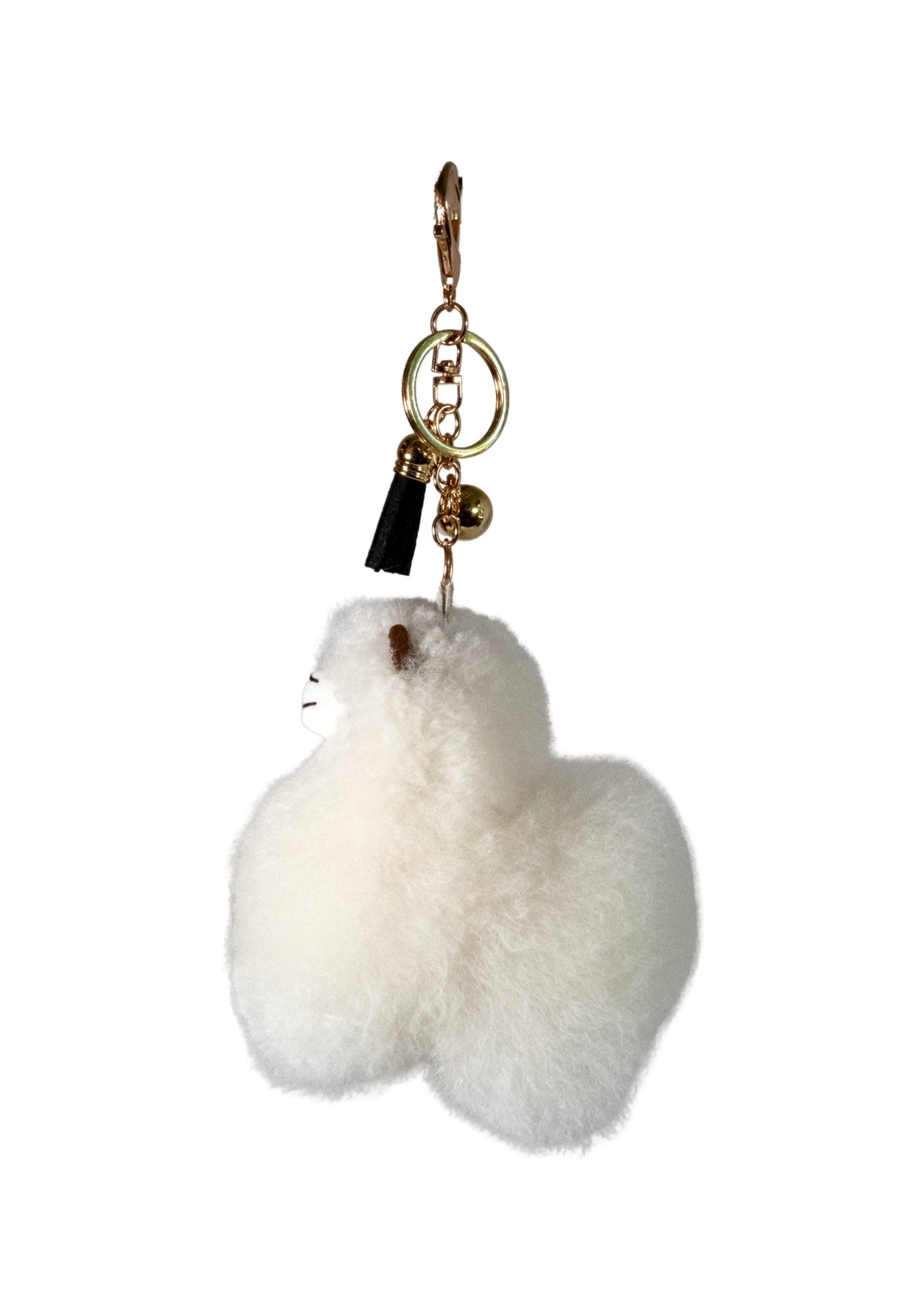 A fluffy white Alpaca fur keychain charm shaped like a small animal, attached to a gold-tone key ring, lobster clasp, and small black tassel on a plain white background.